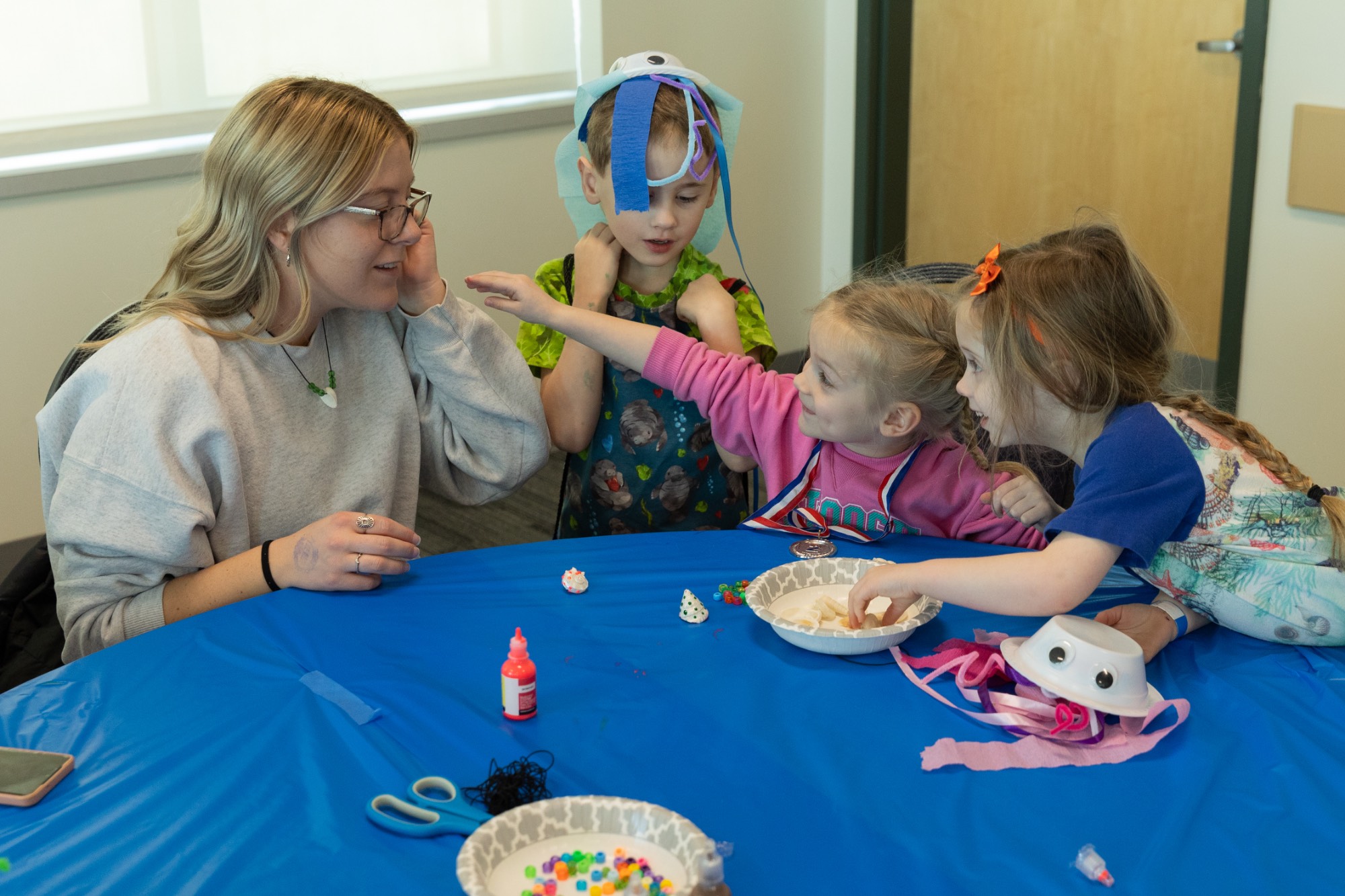 kids smiling while crafting at sibs and kids weekend 2024